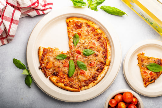 Compostable Round Paper Plate made from Plant with Pizza Slice in it