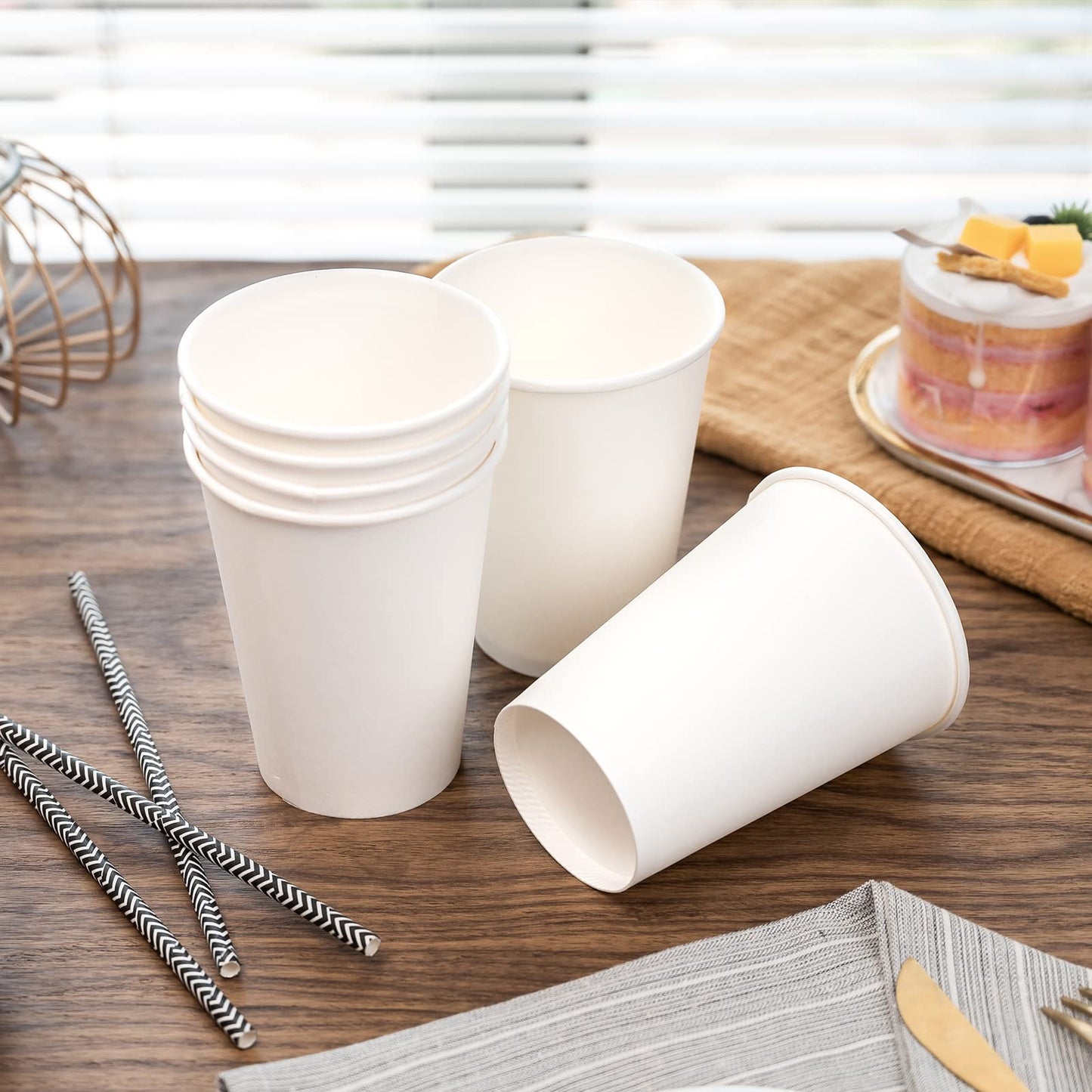 10oz white paper cup with paper straw on the wooden table